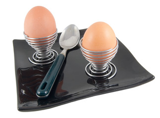 two boiled eggs on plate with spoon