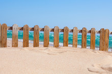 Small Wood Fence In Sand On The Coast