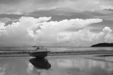 Motorboat On Beach With Dramatic Sky Background, Black And White