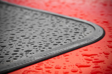 Abstract Of Raindrops Around A Vehicle Window Seal
