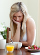 © WavebreakMediaMicro - Tired woman having an healthy breakfast