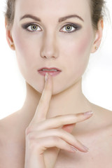 close up portrait of attractive young woman with finger at her l