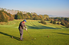 Male Golfer Teeing Off In Autumn