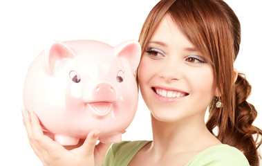 lovely teenage girl with piggy bank