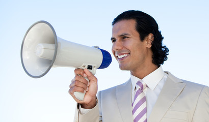 Portrait of a latin business man shouting through a megaphone