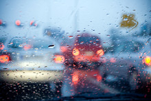 Car Driving In A Rain Storm With Blurred Red Lights