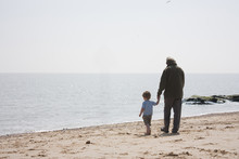 Grandad And Grandson On The Beach