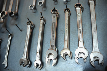 spanners on the wall of auto mechanics workshop