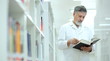 © lightpoet - Renowned scientist/doctor in a library of research center/hospit