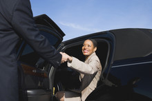 African Businesswoman Getting Out Of Limousine