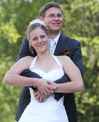 young wedding couple - freshly wed groom and bride posing outdoo