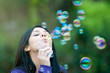 © Rido - Young girl blowing bubbles