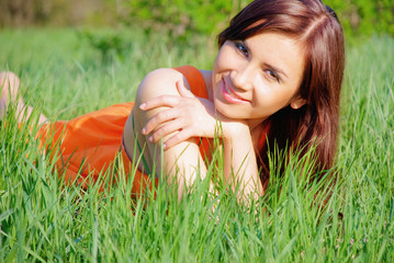 Pretty girl liyng on grass