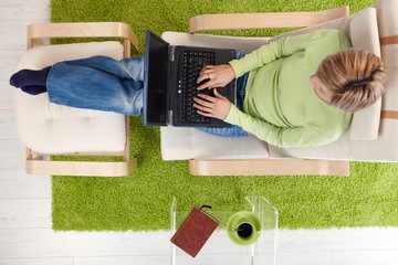 Canvas Print - Woman in armchair with laptop