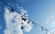 Old Shoes Hanging On Cable Wire