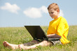 © SergiyN - Smart boy with a laptop on the grass