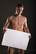 © wtamas - Young naked male stands straight holding a space box