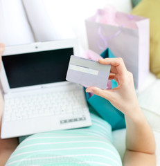 Wall Mural - Close-up of a woman shopping on-line at home