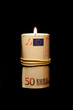 50 euro bill as a candle, on black background