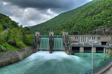 Hydroelectric Power-plant Dam On A River With Water Overflowing The Dam After Heavy Rain