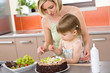 © CandyBox Images - Mother and child with chocolate cake in kitchen