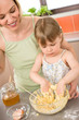 © CandyBox Images - Baking - Woman with child preparing dough