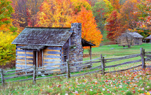 Log Cabins During Autumn In The Mountains.