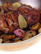 filipino chicken adobo with potatoes in a pan isolated on white