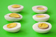 six sliced eggs on green