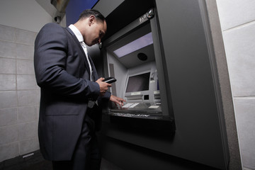 Businessman at an atm machine