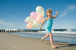 © Gorilla - Little girl playing with balloons at tha beach