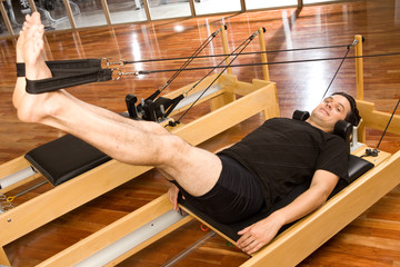 Poster - Pilates man on a reformer