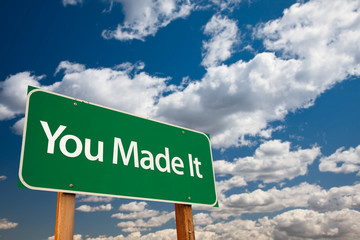 Wall Mural - You Made It Green Road Sign with Sky
