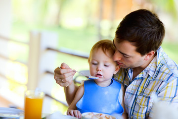 Sticker - Young  father and his daughter having breakfast together