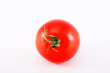 One ripe tomato on a white background