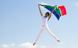 © michaeljung - woman jumping holding south african flag