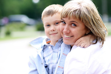 Happy mother and her little son outdoors session