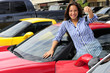 woman showing key of new sports car