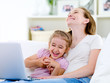 © Valua Vitaly - Laughing mother and daughter with laptop