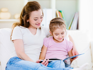 Wall Mural - Mother with daughter reading the book