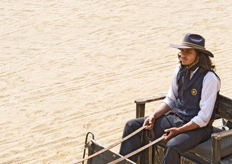 Fototapete - Cowboy Sheriff driving a wagon