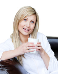 Wall Mural - Smiling woman holding a cup of coffee