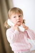 © CandyBox Images - Little girl holding telephone receiver calling