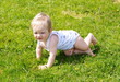 © fotoclassno - The small kid creeps on a grass