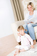 © CandyBox Images - Mother and child - on the phone in living room