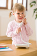 © CandyBox Images - Smiling little girl on phone in lounge