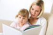 © CandyBox Images - Mother with little girl read book together