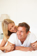 © Monkey Business - Young Couple Relaxing On Bed