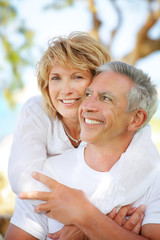 Wall Mural - close-up portrait of a mature couple smiling and embracing.