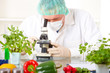 © Monika Wisniewska - Researcher with microscope with a GMO vegetables in the laborato